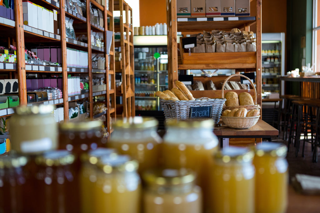 The inside of a general store with jars in the foreground and shelves of products behind