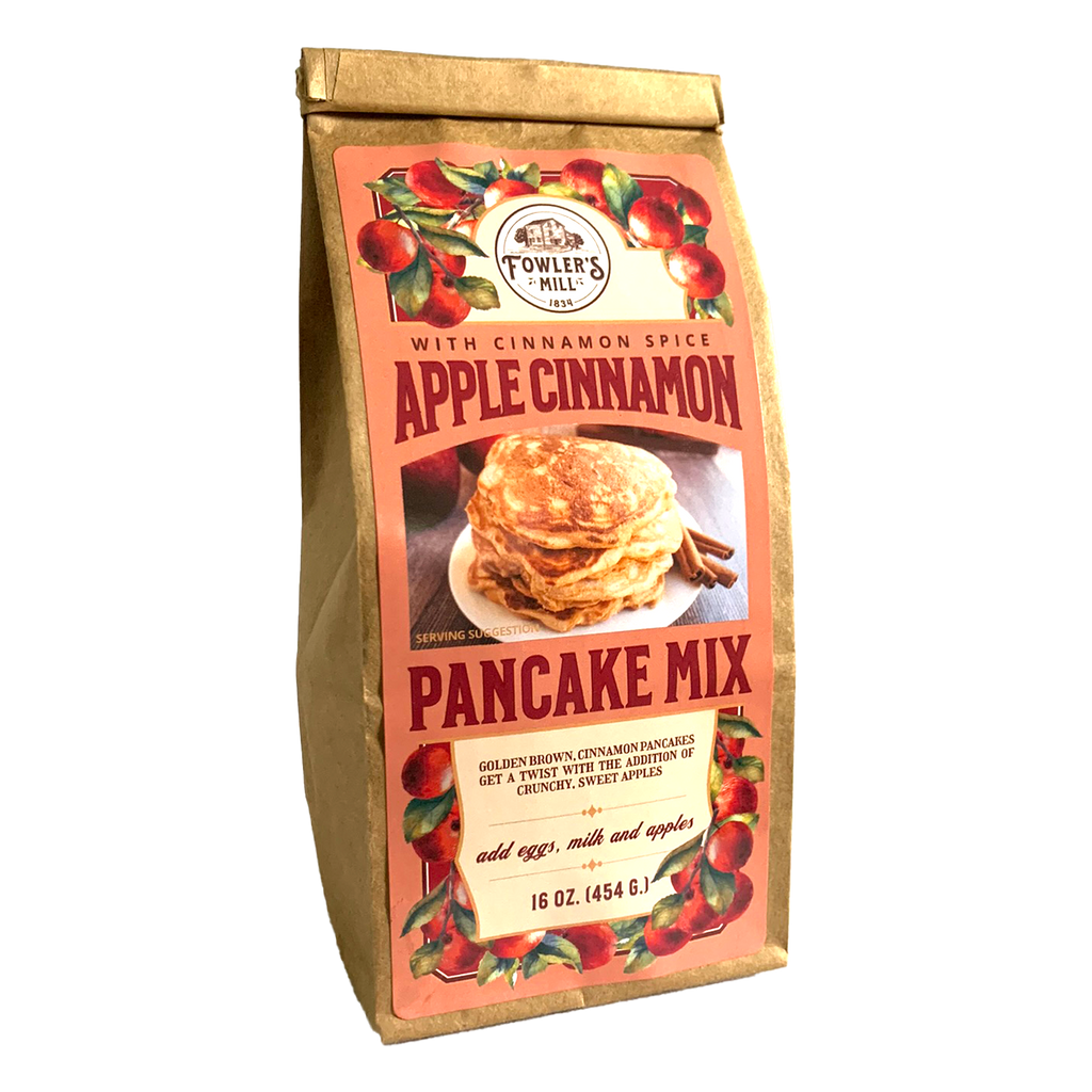 Front of Fowler's Mill Apple Cinnamon Pancake Mix bag - a brown paper bag with a label covered in apples and a delicious stack of apple cinnamon pancakes