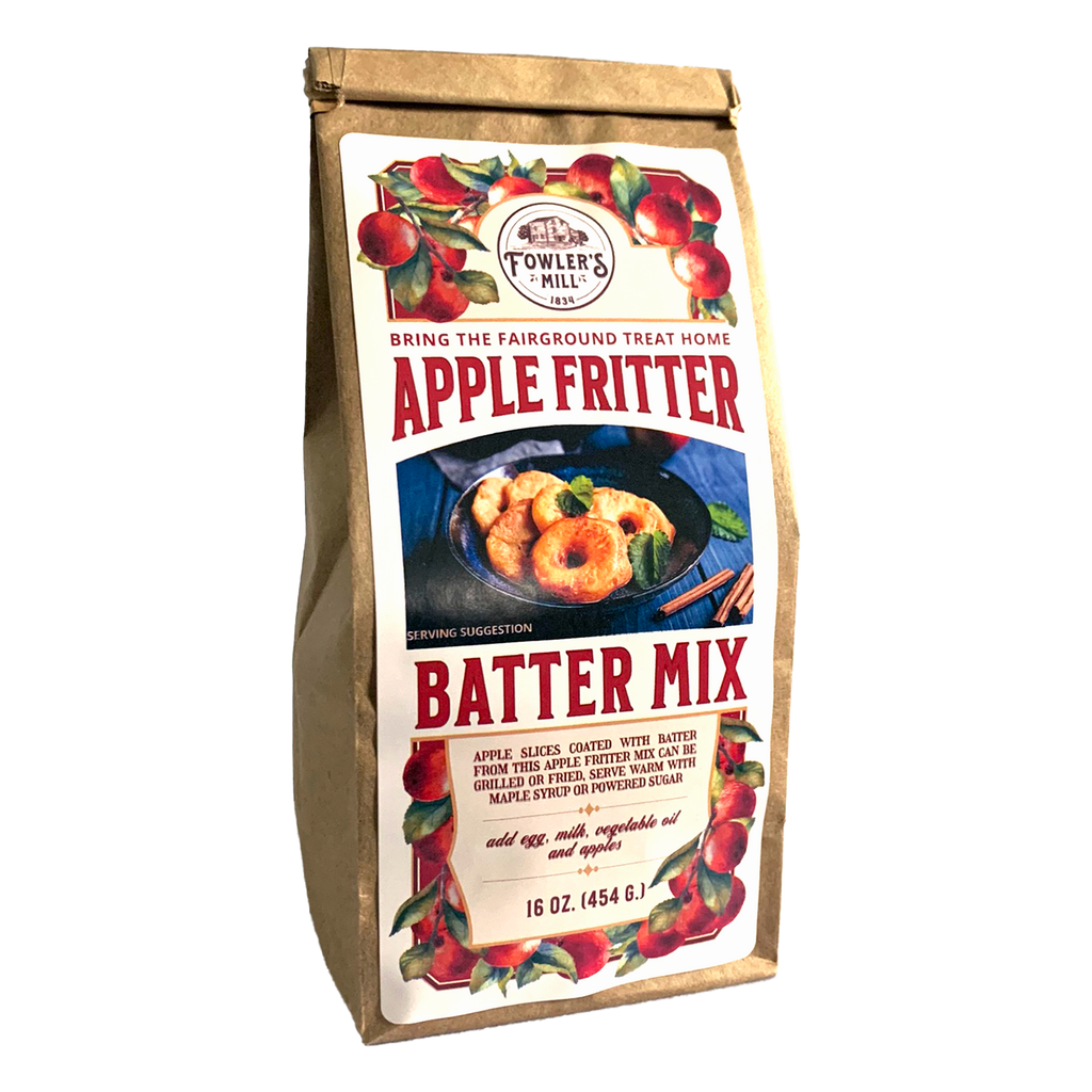 Front of Fowler's Mill Apple Crisp Mix kraft paper bag with glossy label with apples and delicious apple fritters on a blue plate.