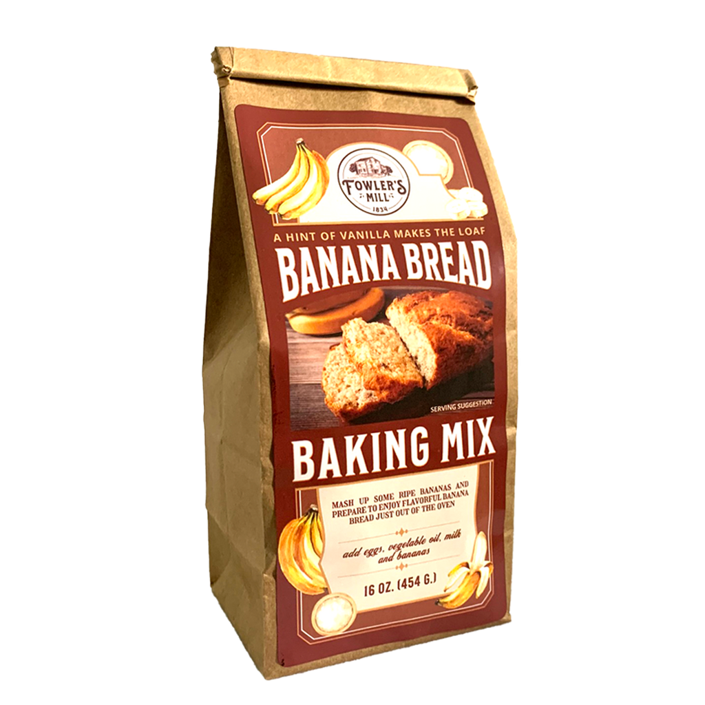 Front of Fowler's Mill Banana Bread Mix kraft paper bag includes glossy label with bananas and a sliced loaf of banana bread.