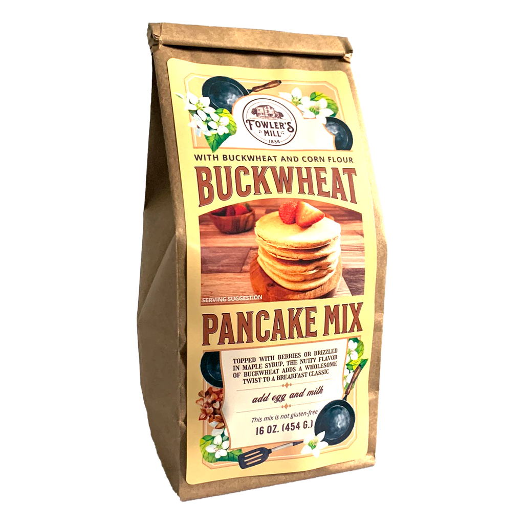 Front of Fowler's Mill Buckwheat Pancake Mix kraft paper bag with glossy label including a stack of buckwheat pancakes with strawberries on top