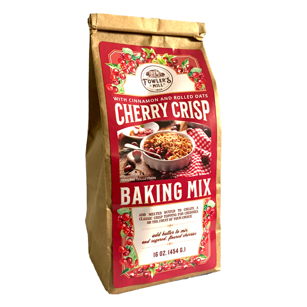 Front of Fowler's Mill Cherry Crisp Mix kraft paper bag with glossy label including a pile of fresh cherries and cherry crisp in a white ramekin