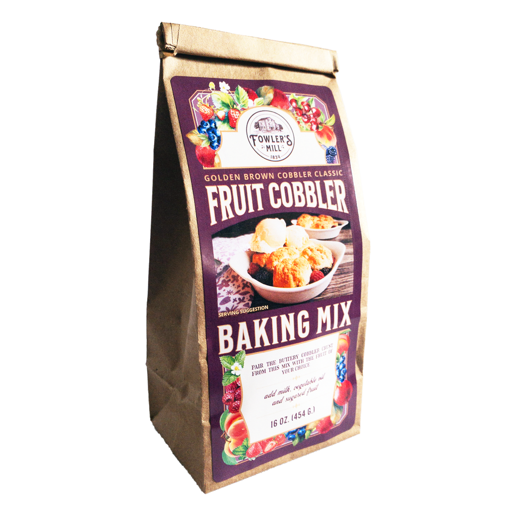 Front of Fowler's Mill Fruit Cobbler Mix kraft paper bag with glossy label showing various fruits and a berry cobbler with vanilla ice cream