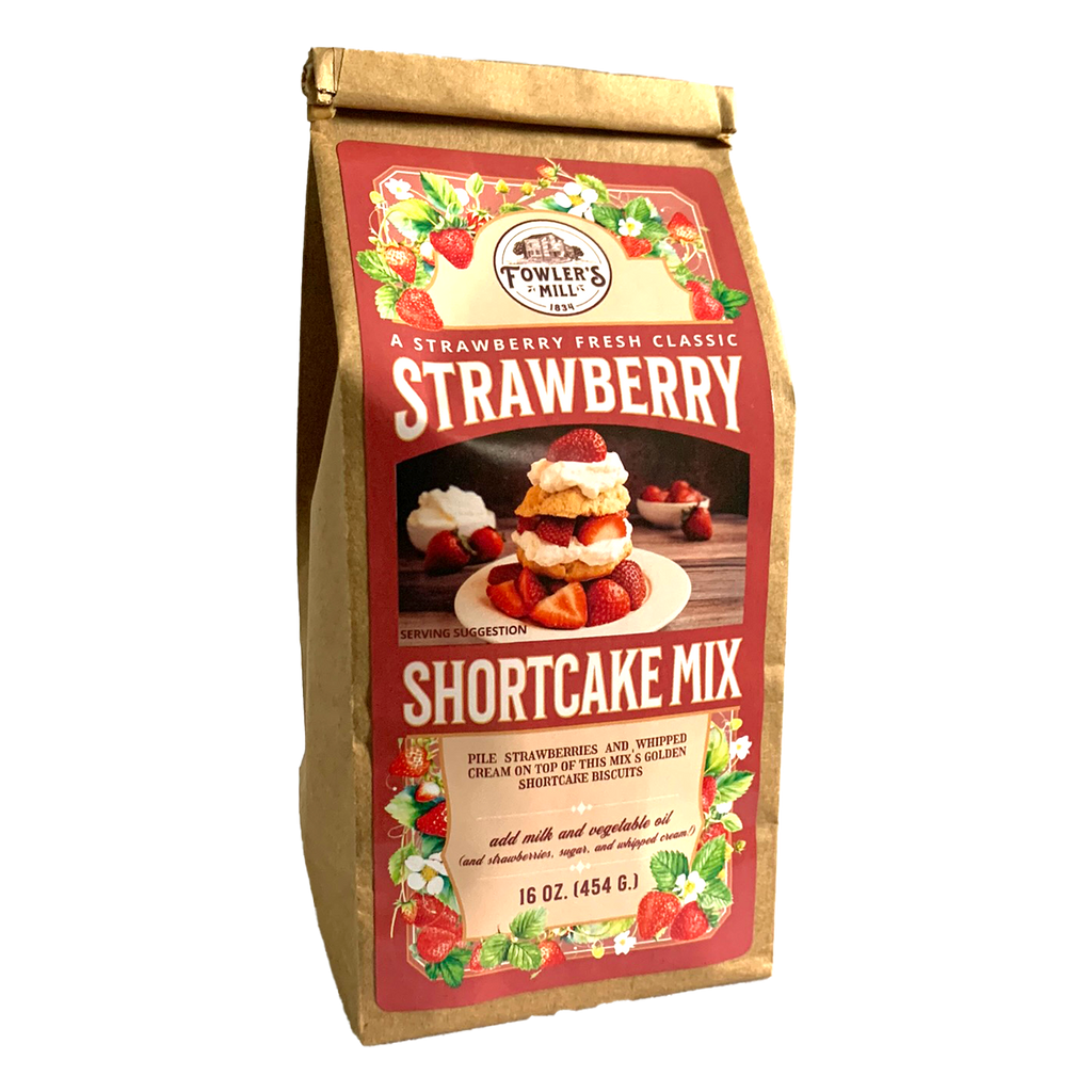 Front of Fowler's Mill Strawberry Shortcake Mix kraft paper bag with glossy logo including a pile of fresh strawberries and a delicious strawberry shortcake piled high with whipped cream and strawberries