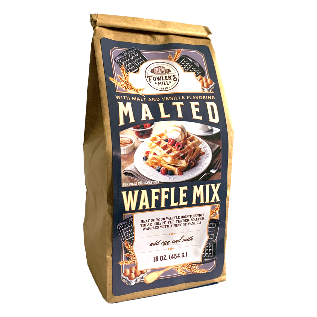Front of Fowler's Mill Malted Waffle Mix kraft paper bag with glossy logo including a stack of waffles with raspberries and caramel.